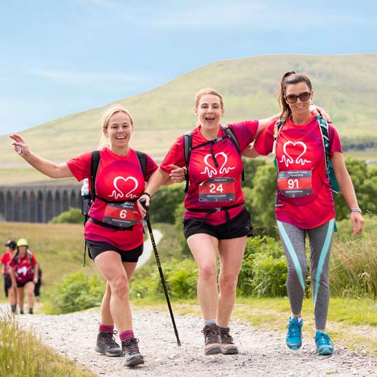 Three ladies in red t-shirts participating in Eight Point Two charity events