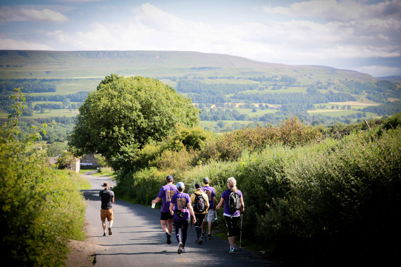 Group walking down narrow country road on event by charity and corporate event organisers Eight Point Two